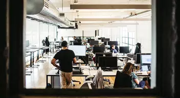 employees working in an open office space virtual